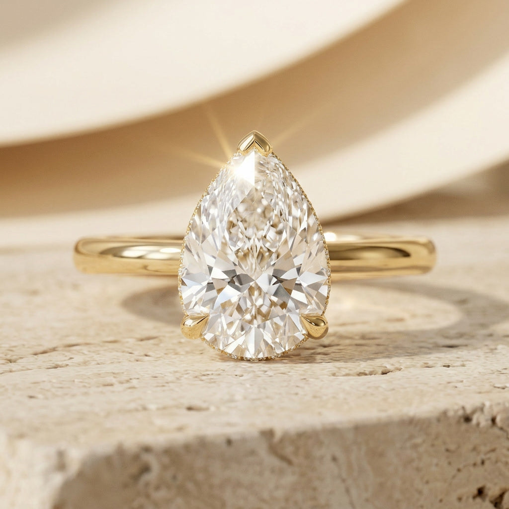 AETERNA ROSÉE pear cut moissanite engagement ring, 3ct, hidden halo, yellow gold — front view