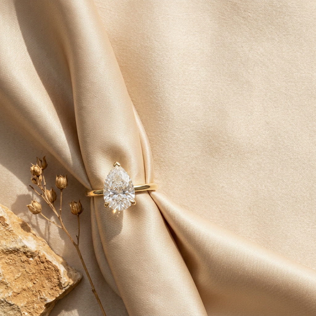AETERNA ROSÉE pear moissanite ring — editorial still life
