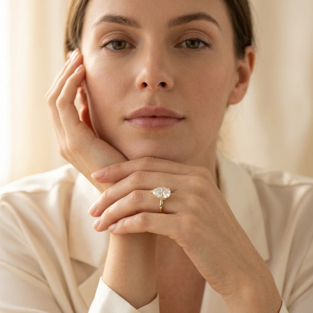 AETERNA ROSÉE pear moissanite ring — worn, face in frame