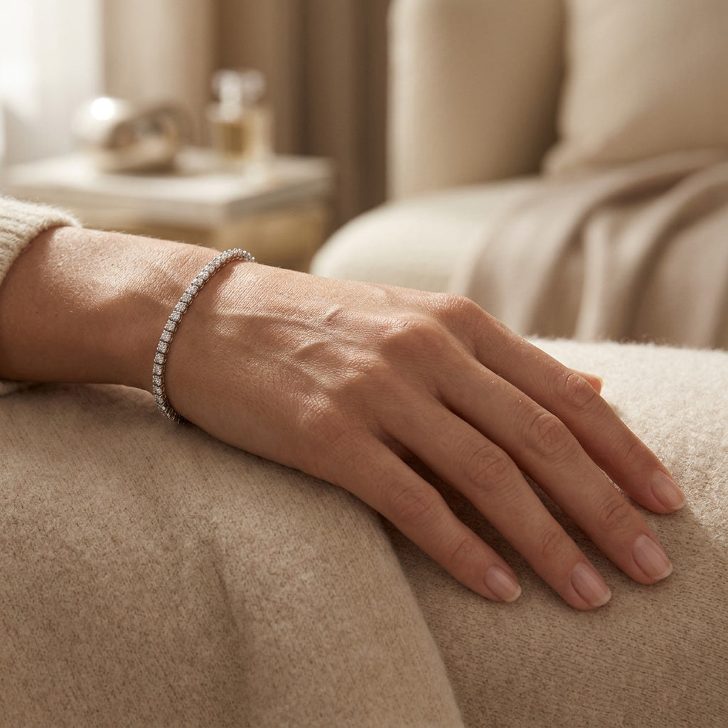 Lab diamond tennis bracelet worn against a neutral interior, lifestyle detail