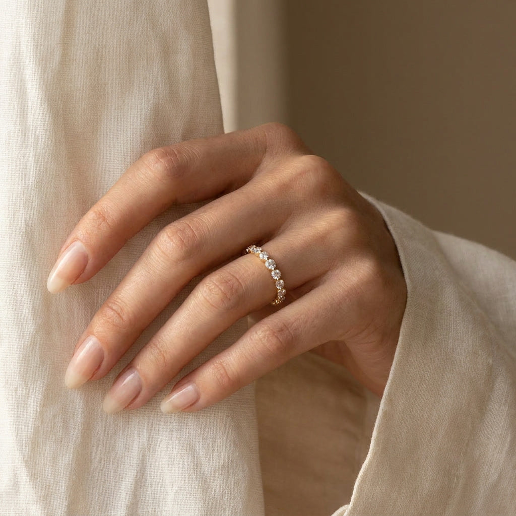 LUMINA SCINTILLE yellow gold moissanite eternity band worn on the hand