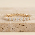 LUMINA SCINTILLE round-cut moissanite eternity band in yellow gold, three-quarter view