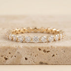 LUMINA SCINTILLE round-cut moissanite eternity band in yellow gold, three-quarter view